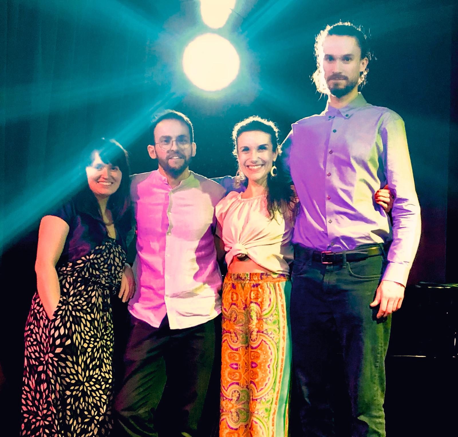 TAJE — the quartet on stage under the spotlight